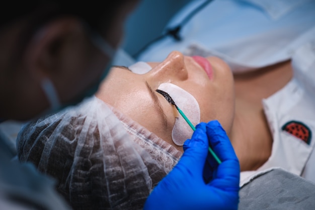 Woman on the procedure for eyelash extensions, eyelashes lamination