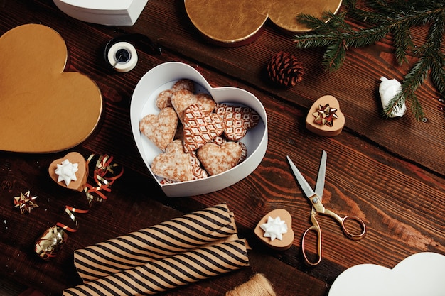 Woman put cookies in a box with gifts around