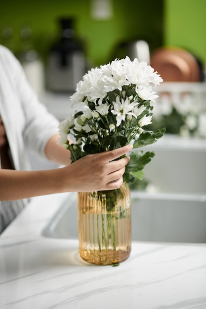 Woman Putting Flowers in Vase