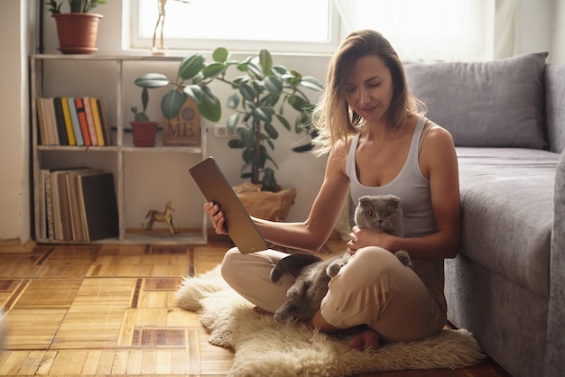 Woman during quarantine works in a cozy home atmosphere