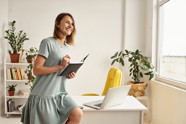 Woman during quarantine works in a cozy home atmosphere