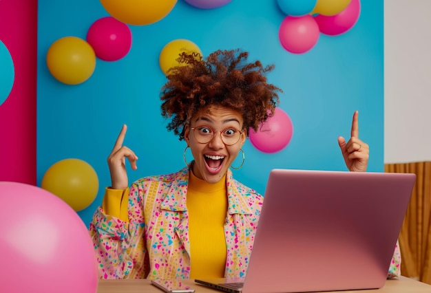 Woman radiating joy points up while watching online content on her laptop Colorful balloons