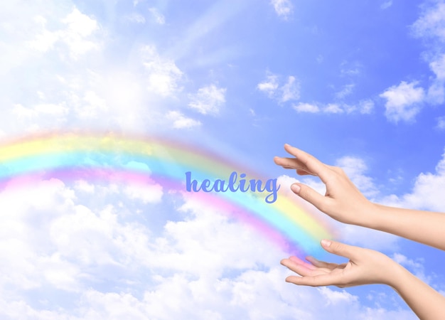 Woman and rainbow as source of healing energy on sunny day closeup