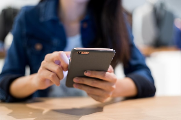 Woman read on cellphone in restaurant