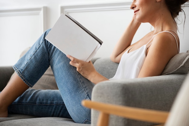 Woman reading a book in a minimal home