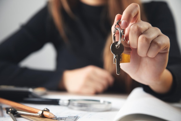 Woman real estate agent holding house key