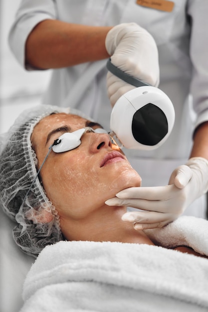 A woman receives ipl therapy in a beauty salon high quality photo