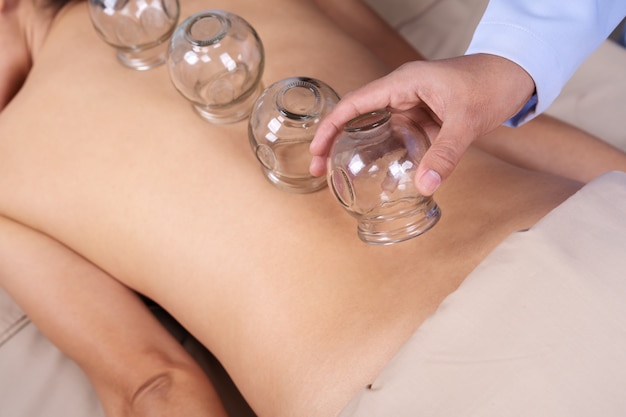 Woman receiving cupping treatment on back