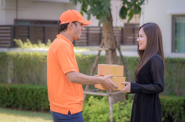 Woman receiving a delivery box from delivery man