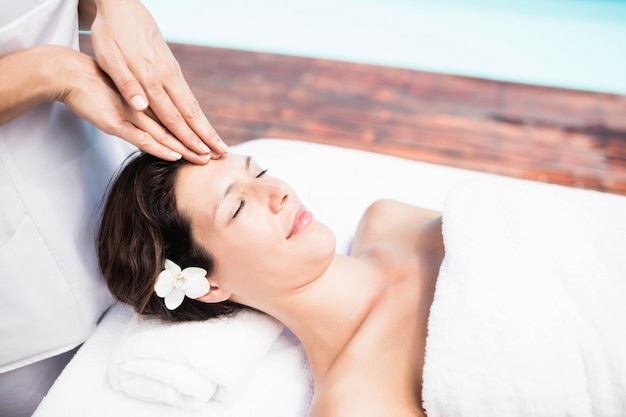 Woman receiving a head massage from masseur in a spa