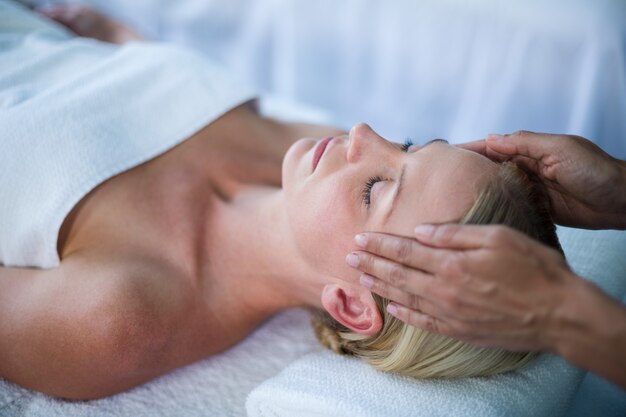 Woman receiving head massage from masseur