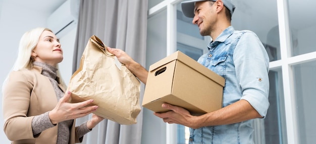 Woman receiving package from delivery man