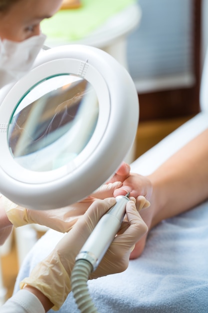 Woman receiving podiatry treatment in Day Spa