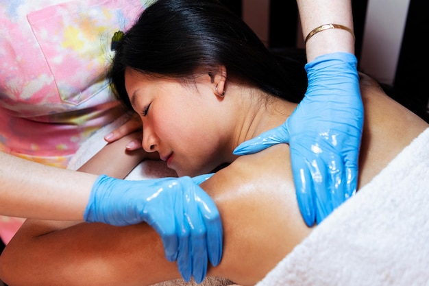 Woman receiving relaxing shoulder and neck massage