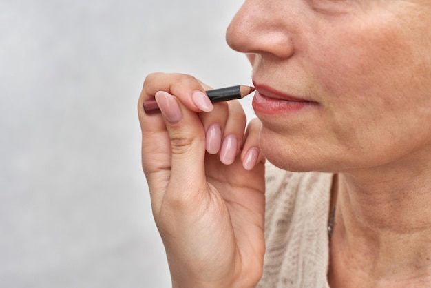 Woman at the reception at the beautician applies makeup