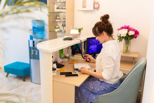 Woman Receptionist Reception Workplace Workplace in Beauty Salon White Interior White Reception Desk