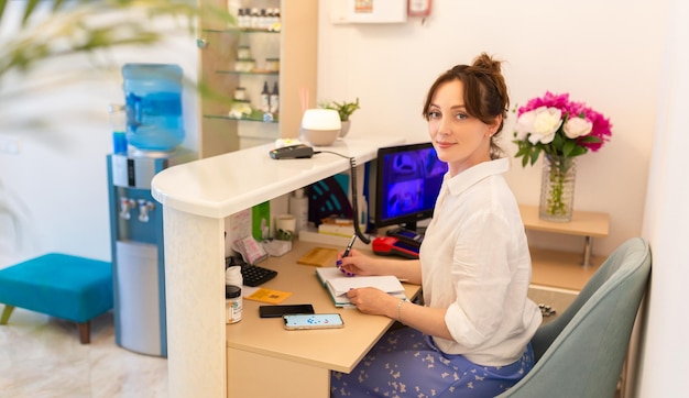 Woman Receptionist Reception Workplace Workplace in Beauty Salon White Interior White Reception Desk