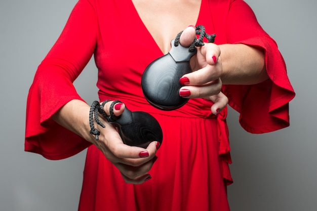 Woman in red dress dancing flamenco with castanets