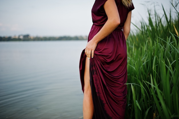 woman in red dress standing in water