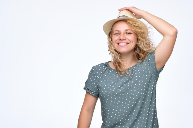 Woman rejoicing at positive news looking at camera with charming smile