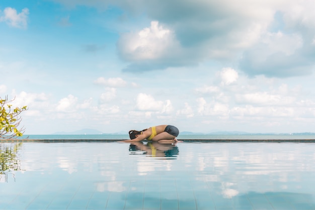 woman relaxes in yoga Child's Pose