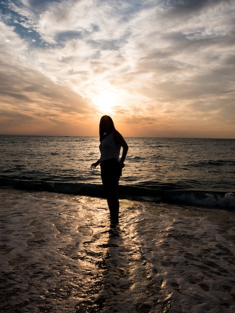 Woman relaxing at the beach during beautiful sunset. Vacation human relaxation