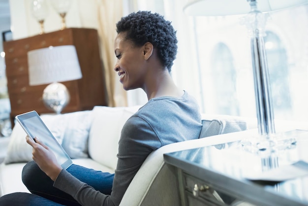 Woman relaxing at home with tablet