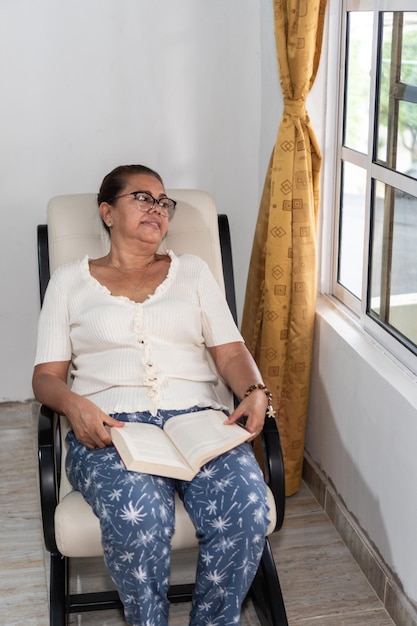 Woman relaxing while reading a book at home