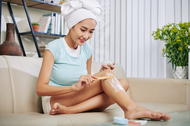 Woman remocing hair at home