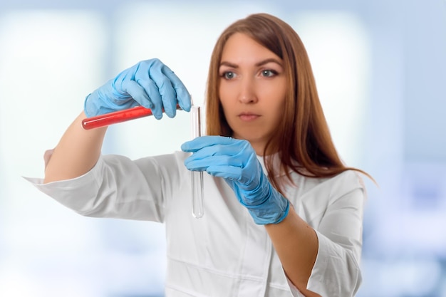 Woman researcher is surrounded by medical vials and flasks isolated on white background