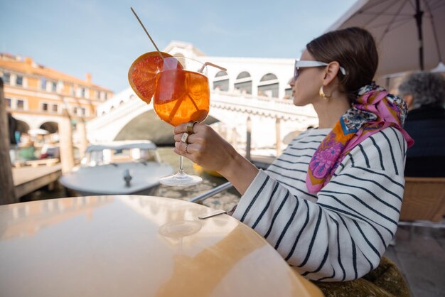 Woman rest at outdoor cafe on grand canal traveling venice