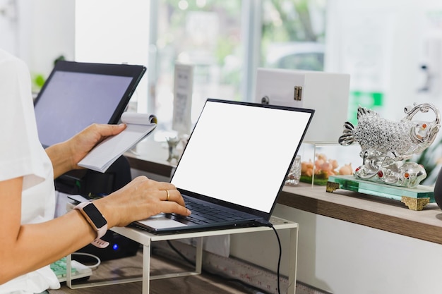 Woman restaurant owner working on laptop at cashier counter