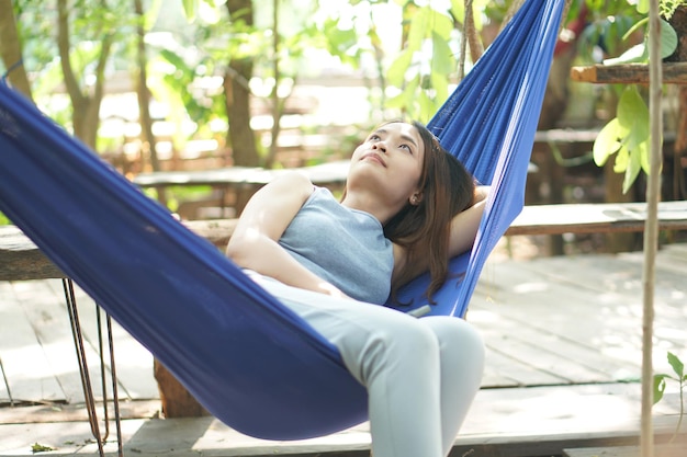 Woman resting in a hammock at a coffee shop