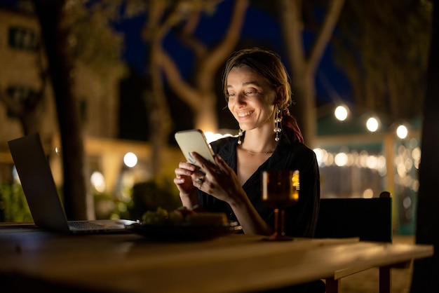 Woman resting with laptop at evening time outdoors