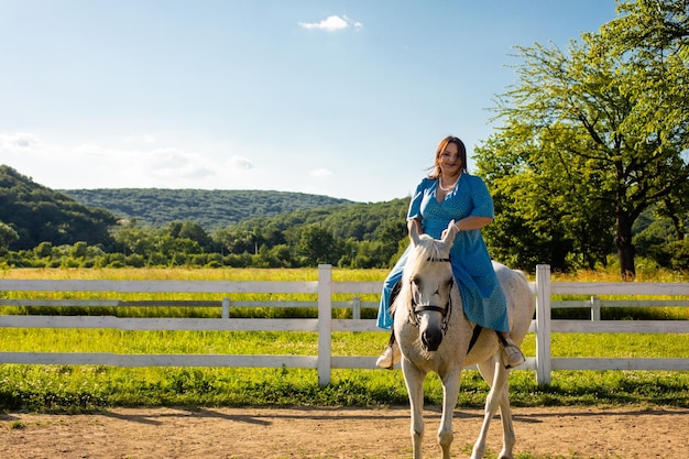 The woman restores her mental health by riding a horse