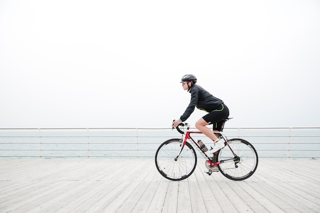 Woman riding on a bicycle outdoors on the beach