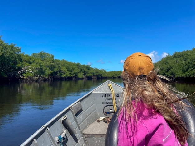 Woman riding a boat in a mangrove in Porto Seguro Bahia Brazil