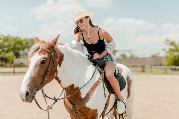 Woman riding a horse in a countryside