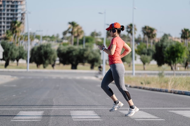 A woman running across a zebra crossing