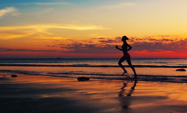 Woman running  along the sea coast