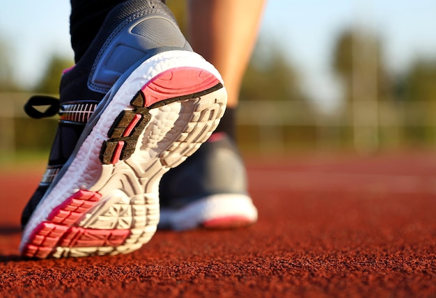 Woman running on athletic track at afternoon