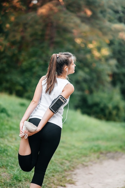 Woman running in autumn fall forest. Healthy lifestyle . Fit ethnic Caucasian fitness model.