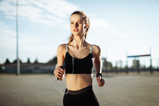 woman running outdoors with the headphones on