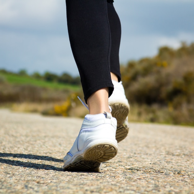 "Woman's feet in sneakers"