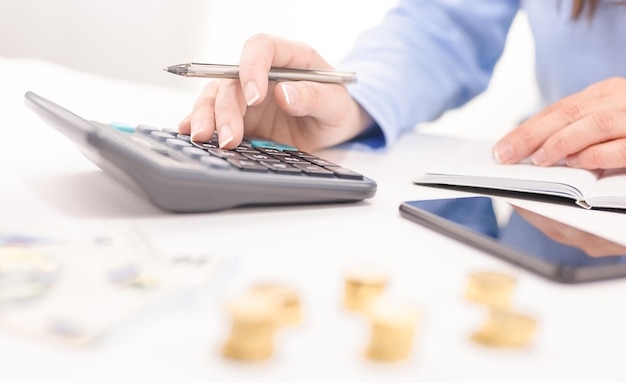 Woman's hand on calculator Management of expenses taxes