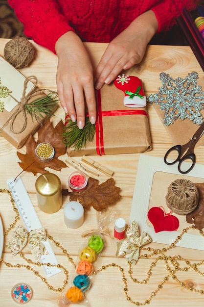 Woman's hand creating Christmas decorations