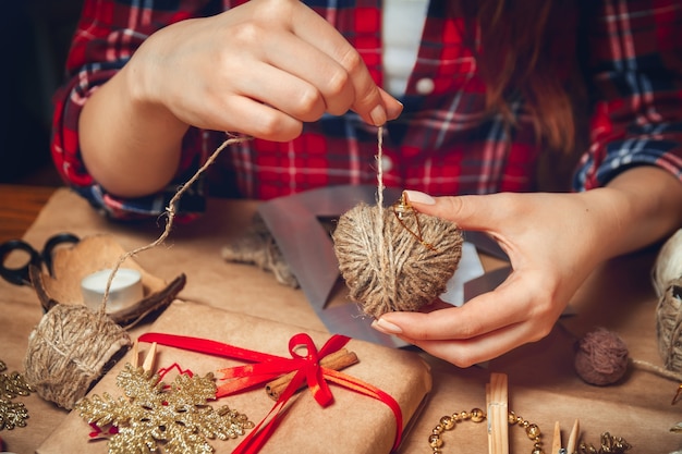 Woman's hand creating Christmas decorations