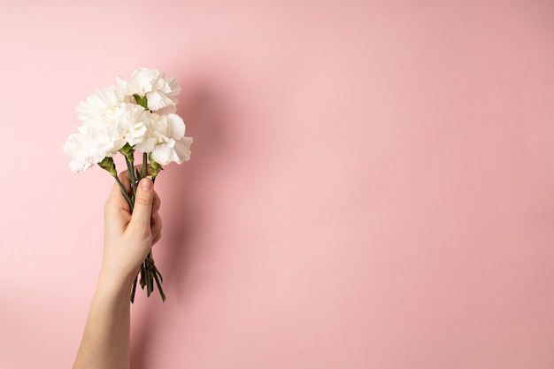 Woman's hand holding flowers bouquet