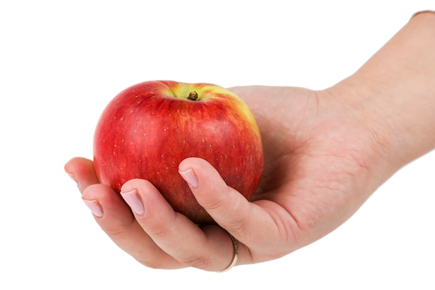 Woman's hand holding red apple isolated on a white background