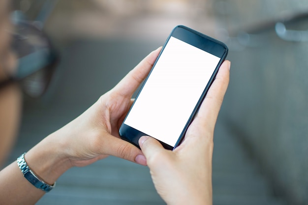 Woman's hand holding smart phone with blur background. selective focus and soft focus.